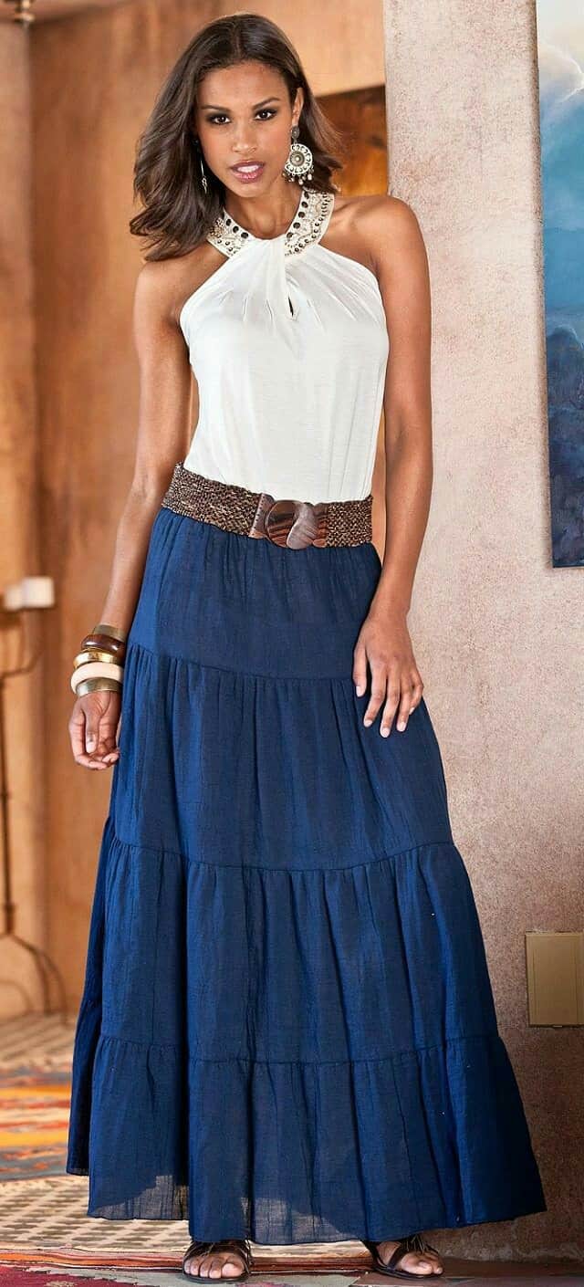 woman wearing blue long skirt and ivory embellished tank top 