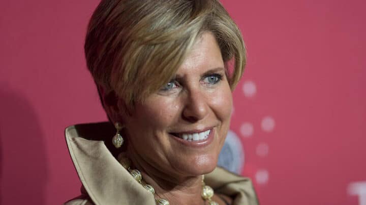 Close-up of Suze Orman in front of a pink background.