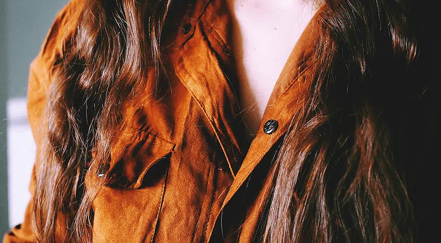 close up of woman wearing suede shirt