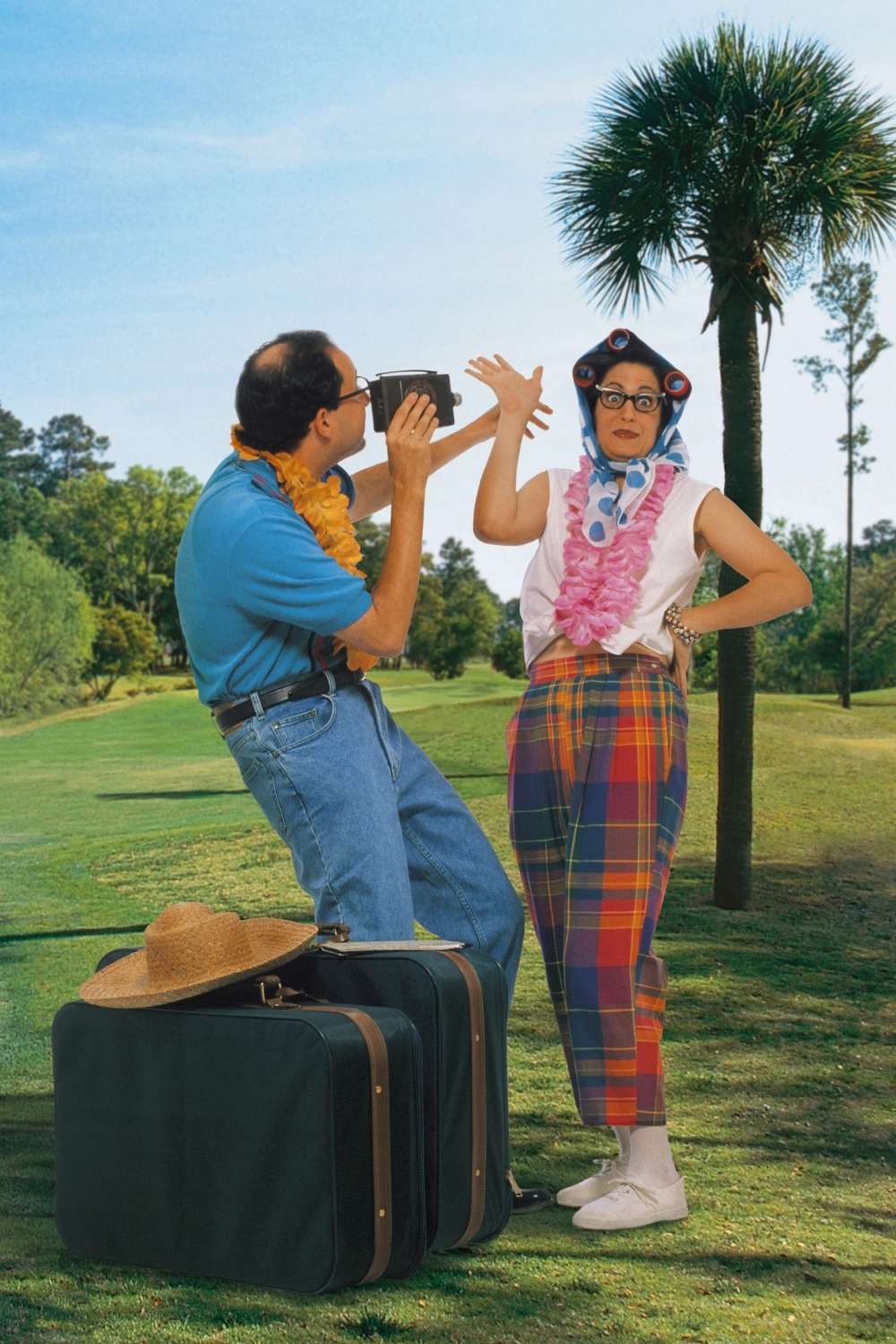 Tacky couple takes photo on golf course.