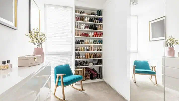 View of inside woman's shoe closet with too many pairs of shoes.