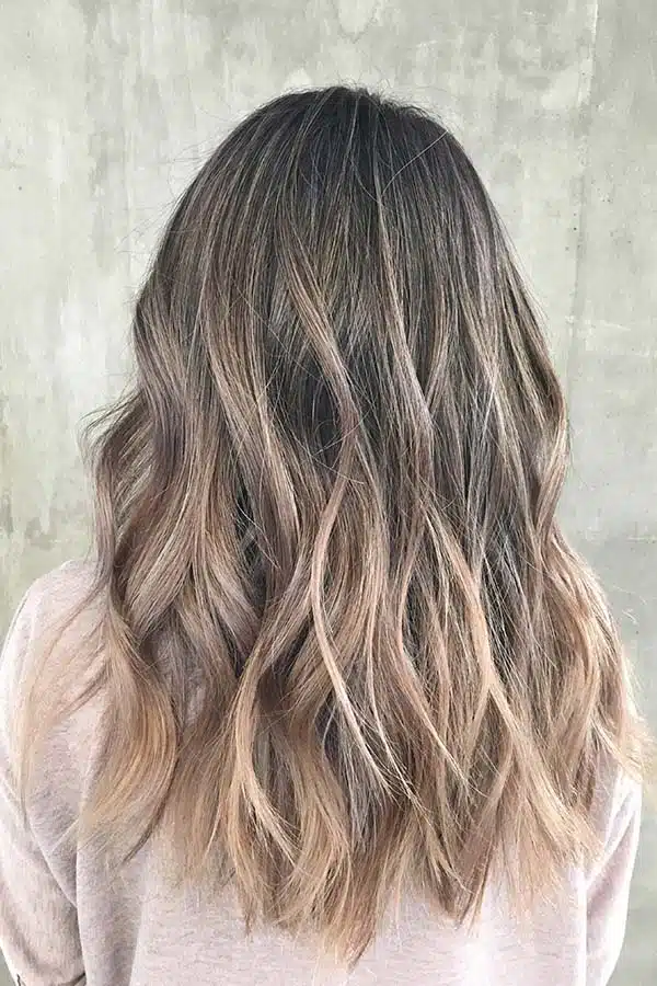 View from the back of a woman's hair with highlights and lowlights.