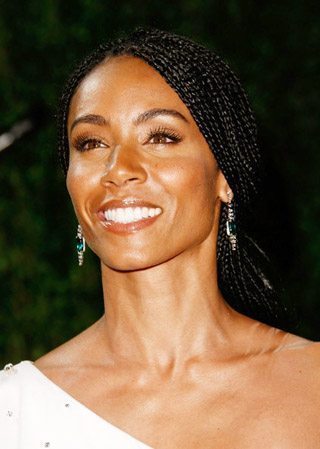 Jada Pinkett Smith with her hair in braids and a low ponytail.