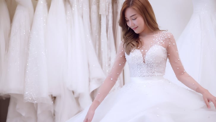 Woman tries on wedding gown chosen by David's Bridal wedding consultant.