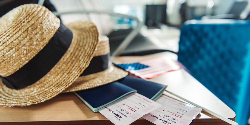 Straw hat and passport on a table in airport