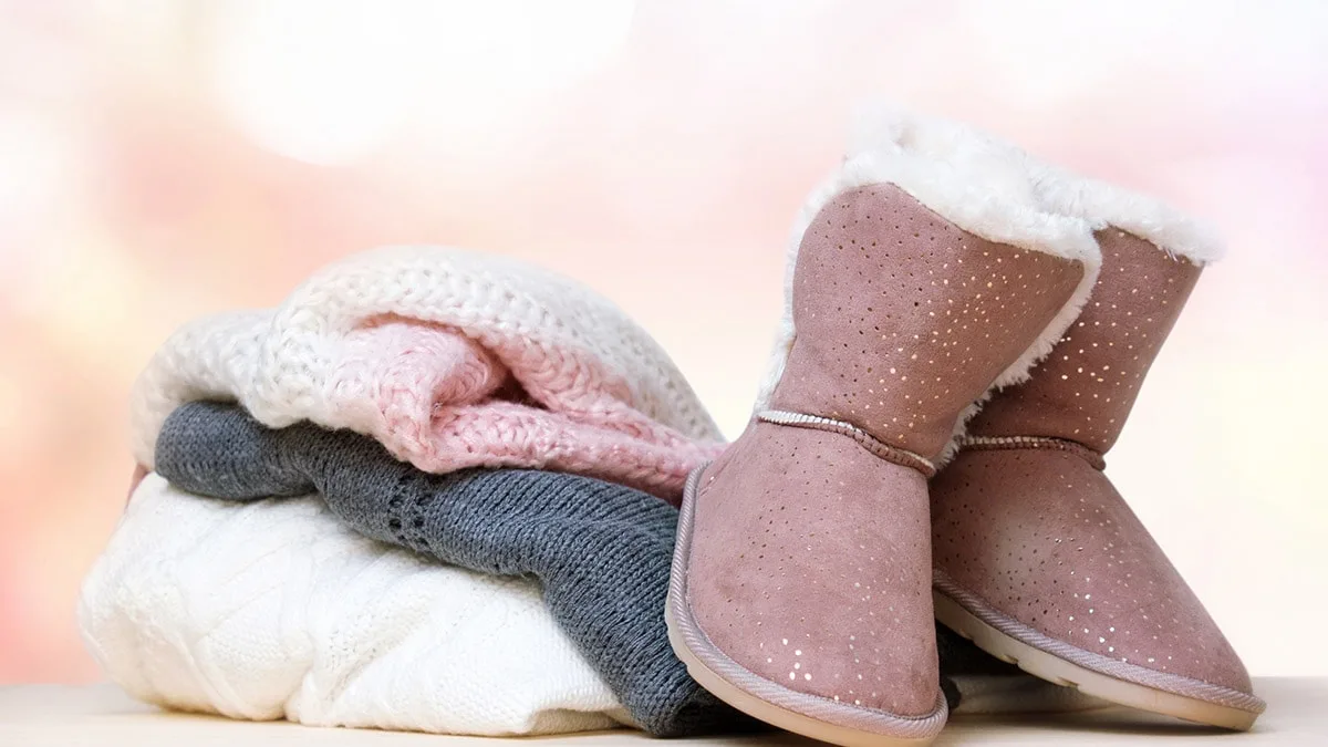 Ugg boots with a pile of sweaters. I love Uggs!