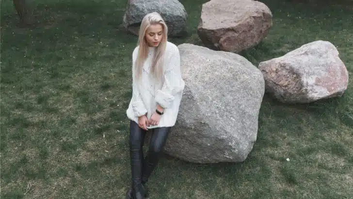 Overhead view of woman wearing leather pants with sweater outside.