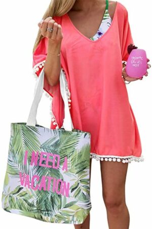 Model wearing coral beach cover-up with fringe detail.