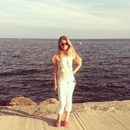 girl in front of ocean wearing capris