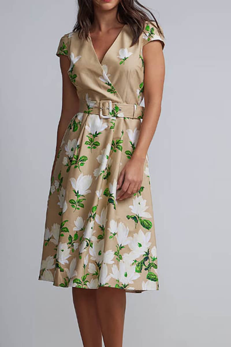 Woman wearing belted floral dress.