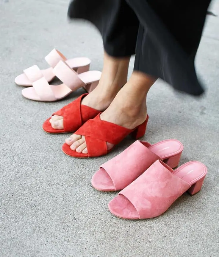 white, red and pink pairs of mules with woman's feet in the red pair