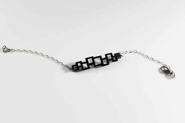 silver chain bracelet with geometric wood pattern