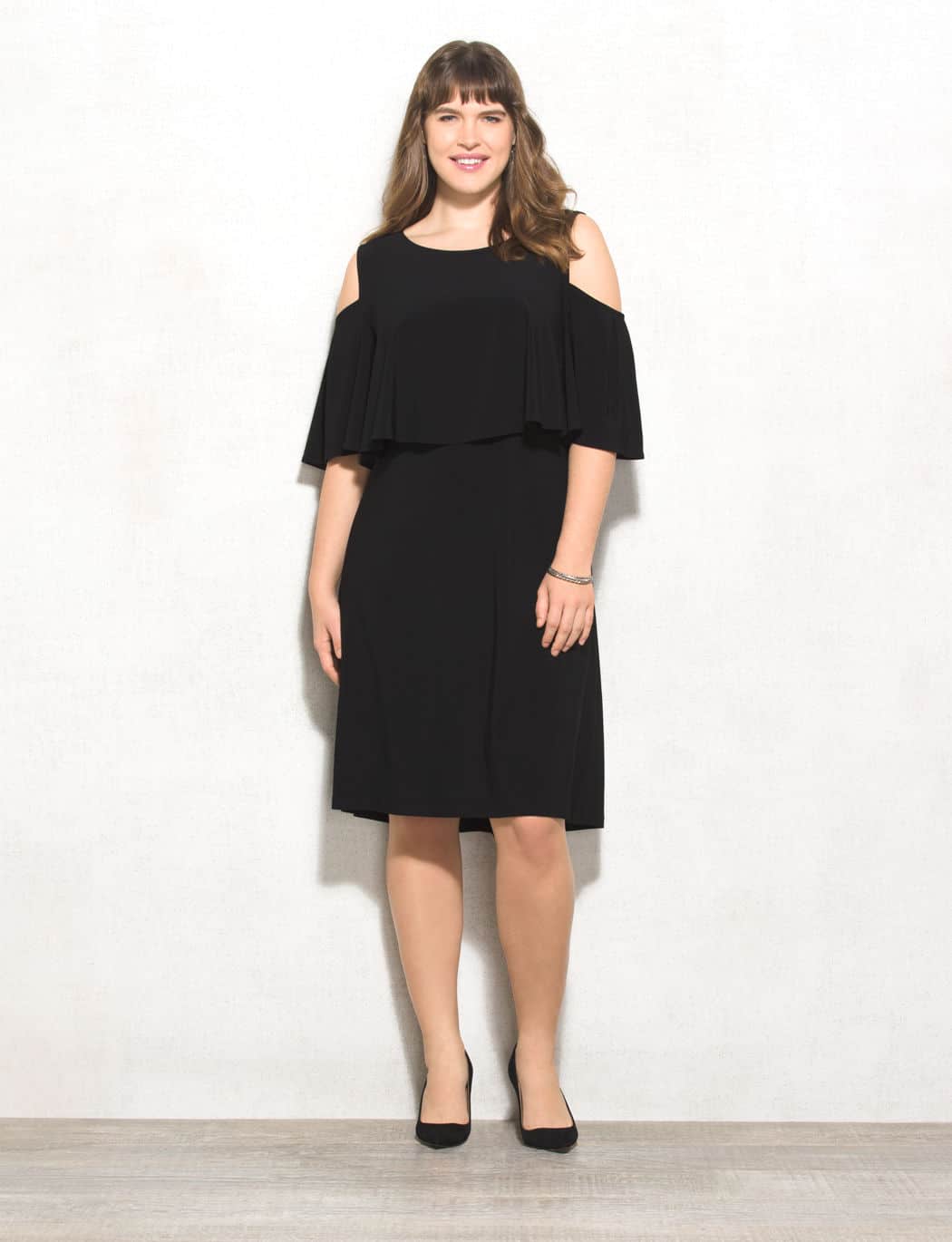 plus-size dresses - woman wearing black, off the shoulder holiday dress