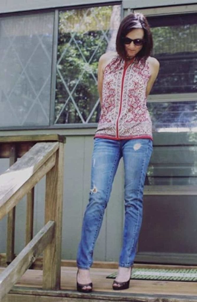 Distressed denim jeans with heels and patterned top