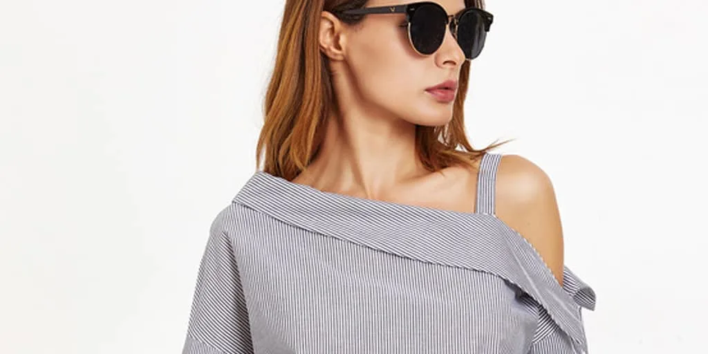Woman wearing sunglasses and pinstriped, asymmetrical top