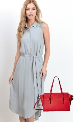 Woman in blue dress with bright red purse