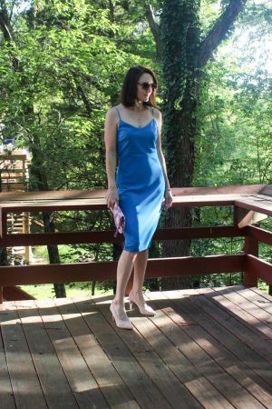 Blue midi dress with blush shoes and floral handbag