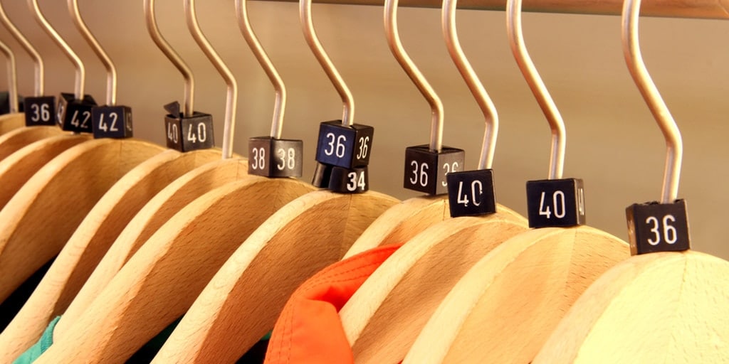Clothes on hangers with sizes marked