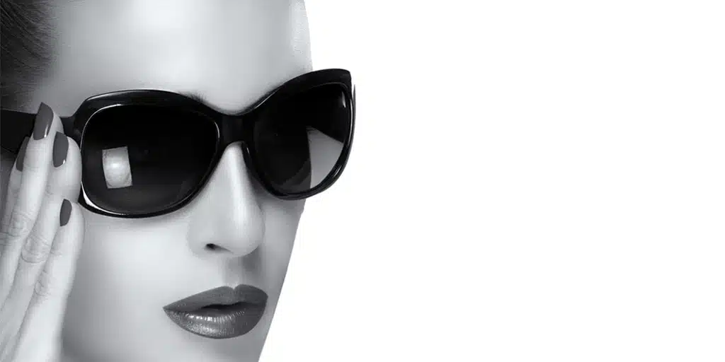 Black and white image of woman wearing large sunglasses