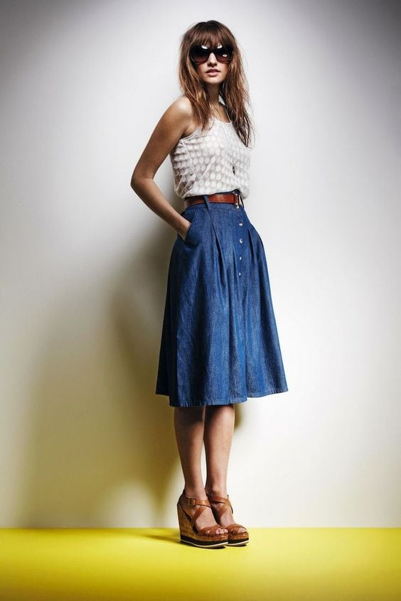 Woman wearing long a-line denim skirt with tank top and wedges