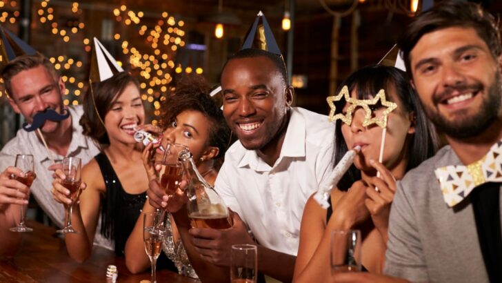 Friends celebrating wearing New Year's Eve outfits at a bar.