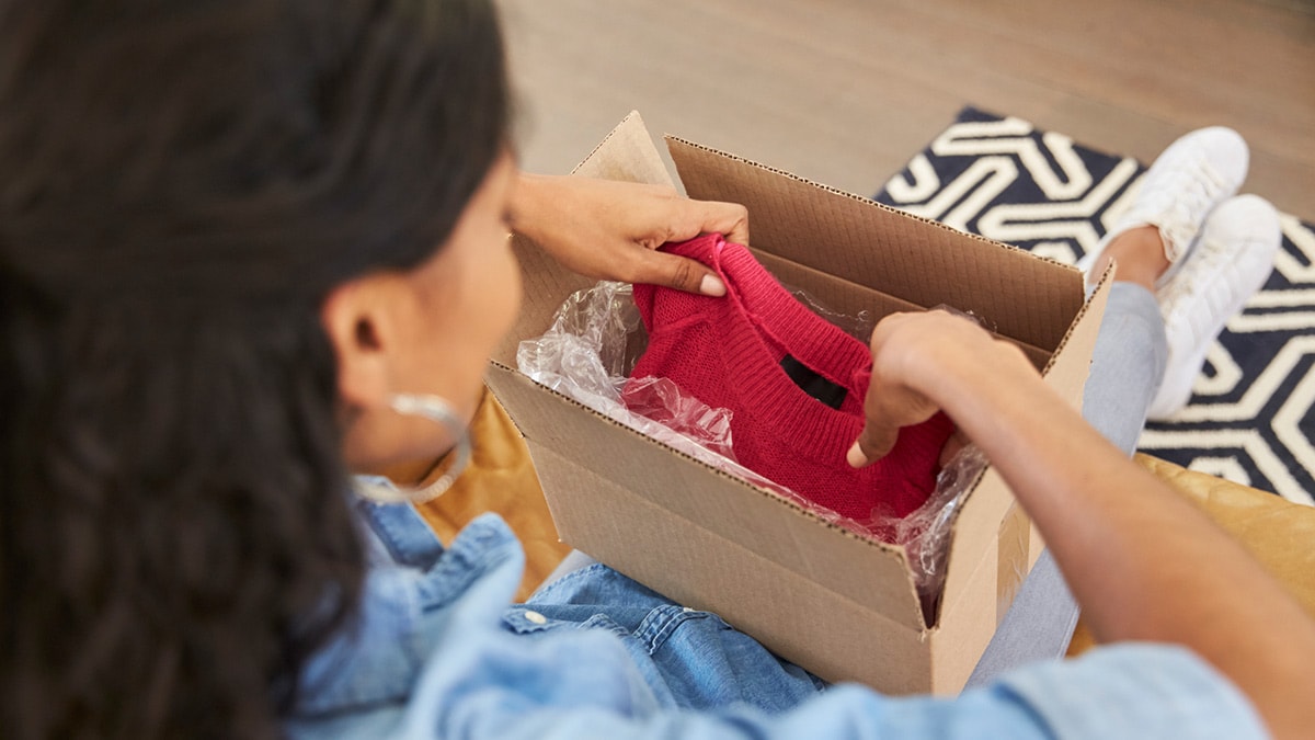 Woman opening a box of clothes