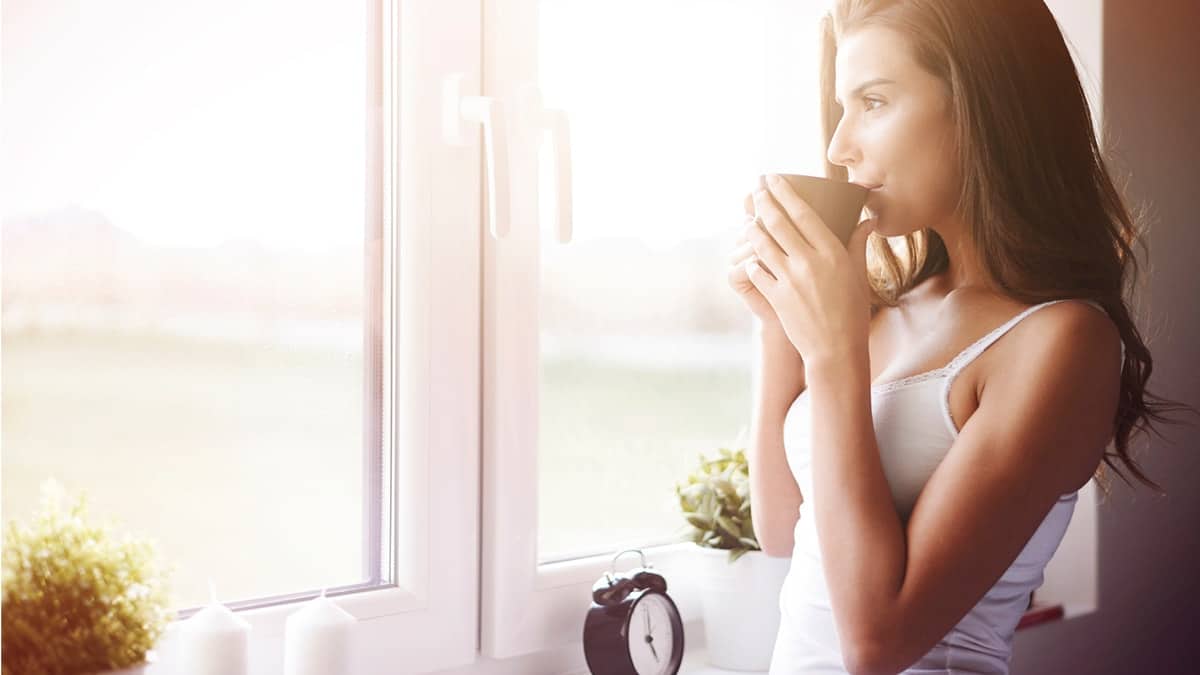 Woman lounging at home and drinking coffee
