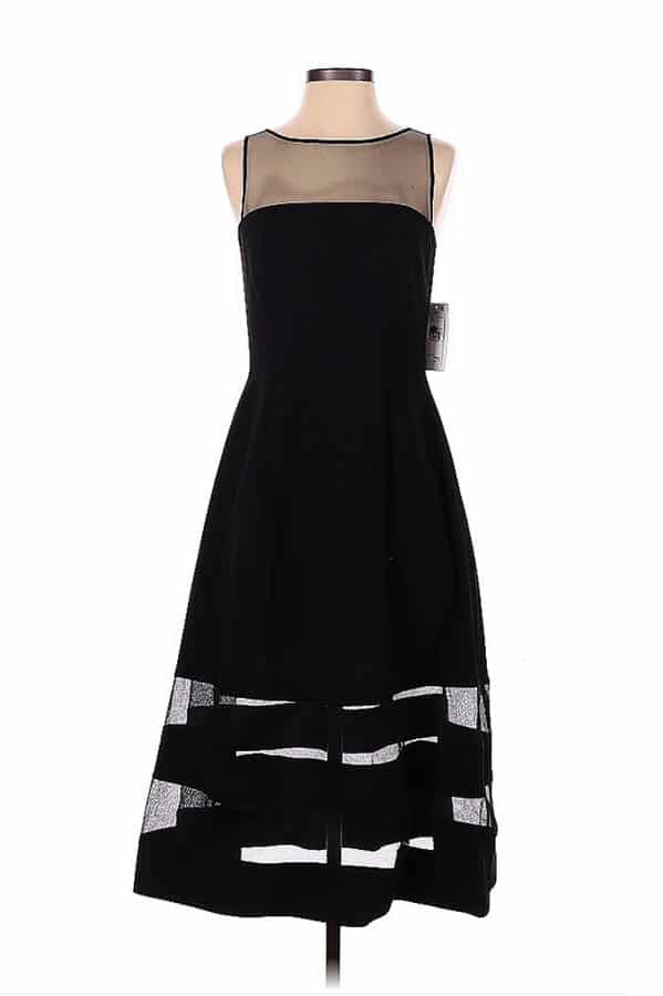 Black holiday dress on mannequin with sheer panels.