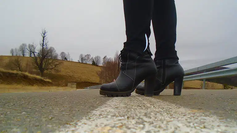 Close up of women's fashion boots in the road