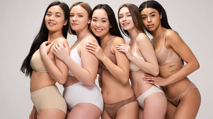 A multiethnic group of five women wearing different types of panties.