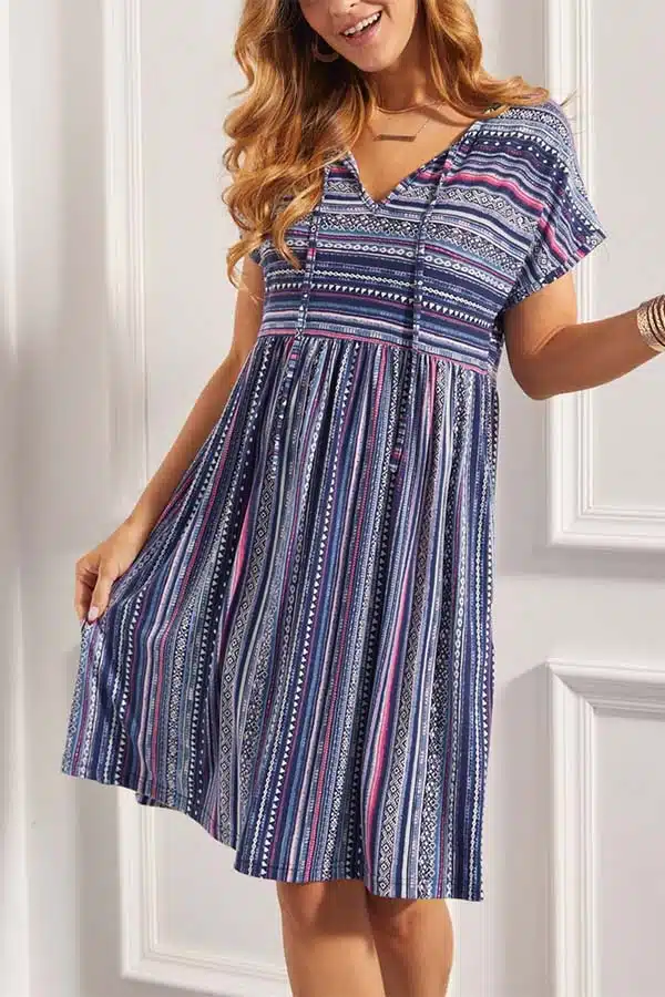 Model wears empire waist dress with stripes, suitable for a woman with a long torso.
