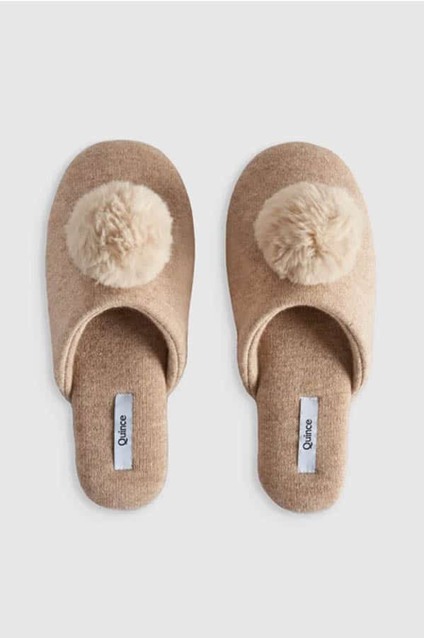 Cashmere slippers from Quince in brown, with cream colored puff.