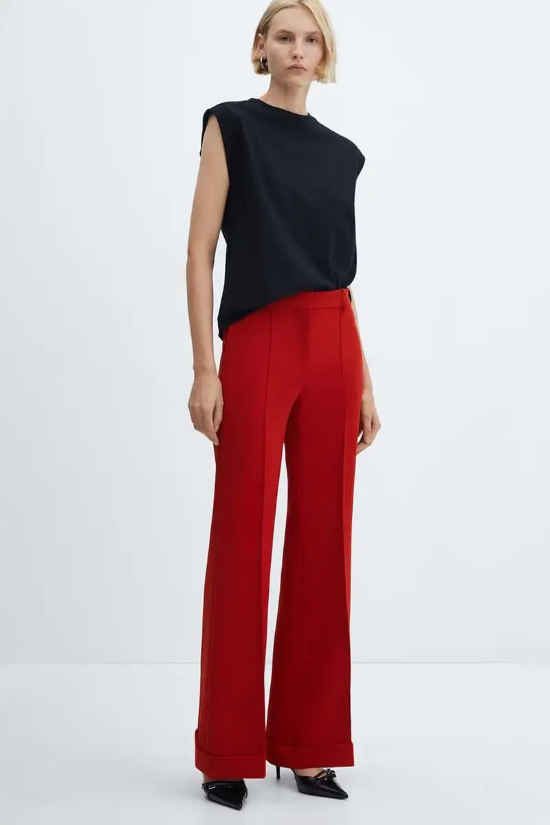 Model wears red wide-legged pants and black top.