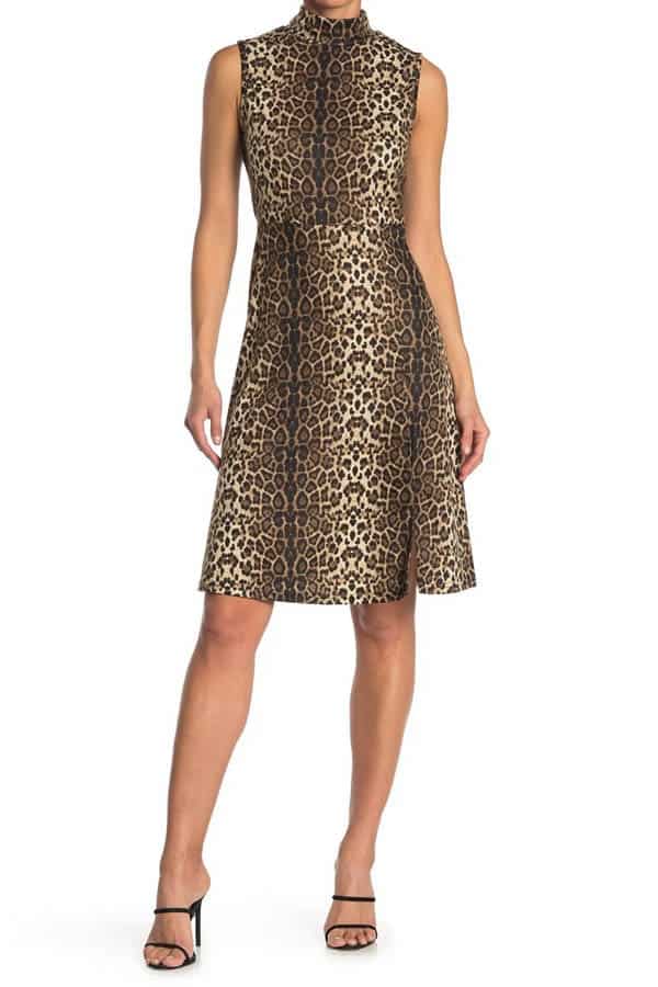 Close-up of model wearing sleeveless, leopard-print dress with mock turtleneck.