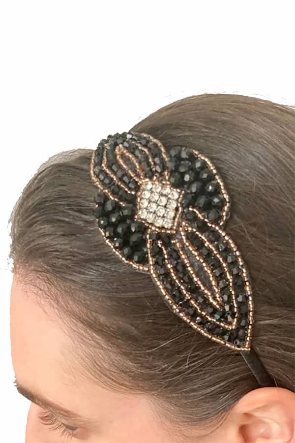 Close up of retro beaded headband in woman's hair.