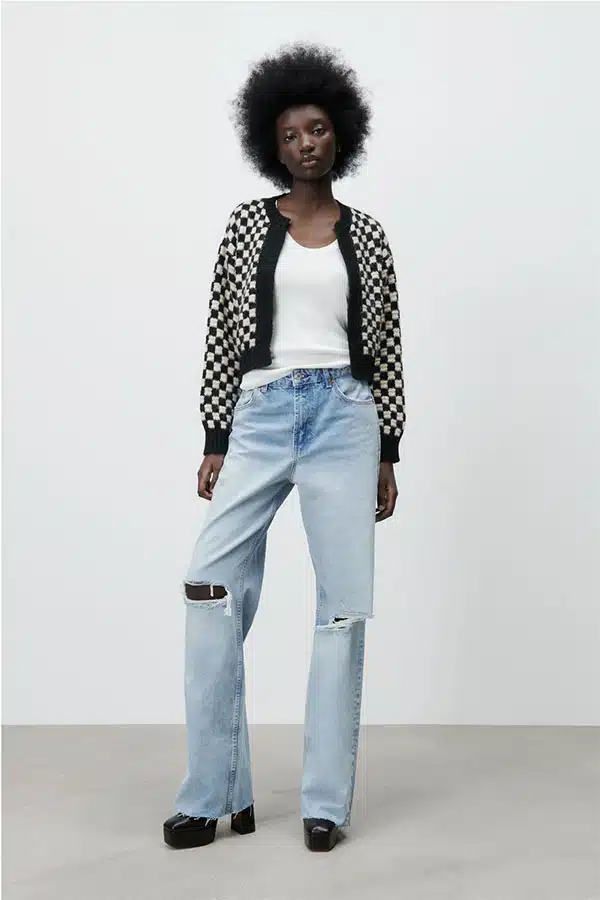 Model wearing knit checkered cardigan. 