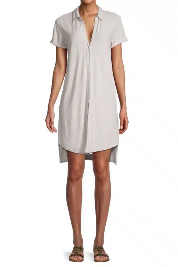Model wears neutral shirt dress on sale at Saks Off 5th.