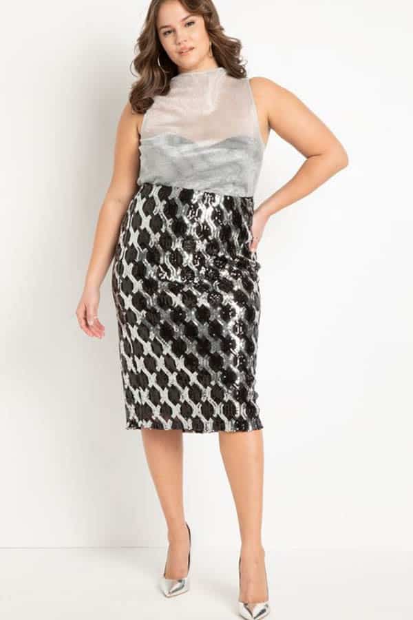 Model wears sequin midi skirt from plus-size clothing store Eloquii.