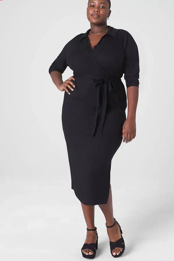 Model wears black dress from plus-size clothing store Lane Bryant.