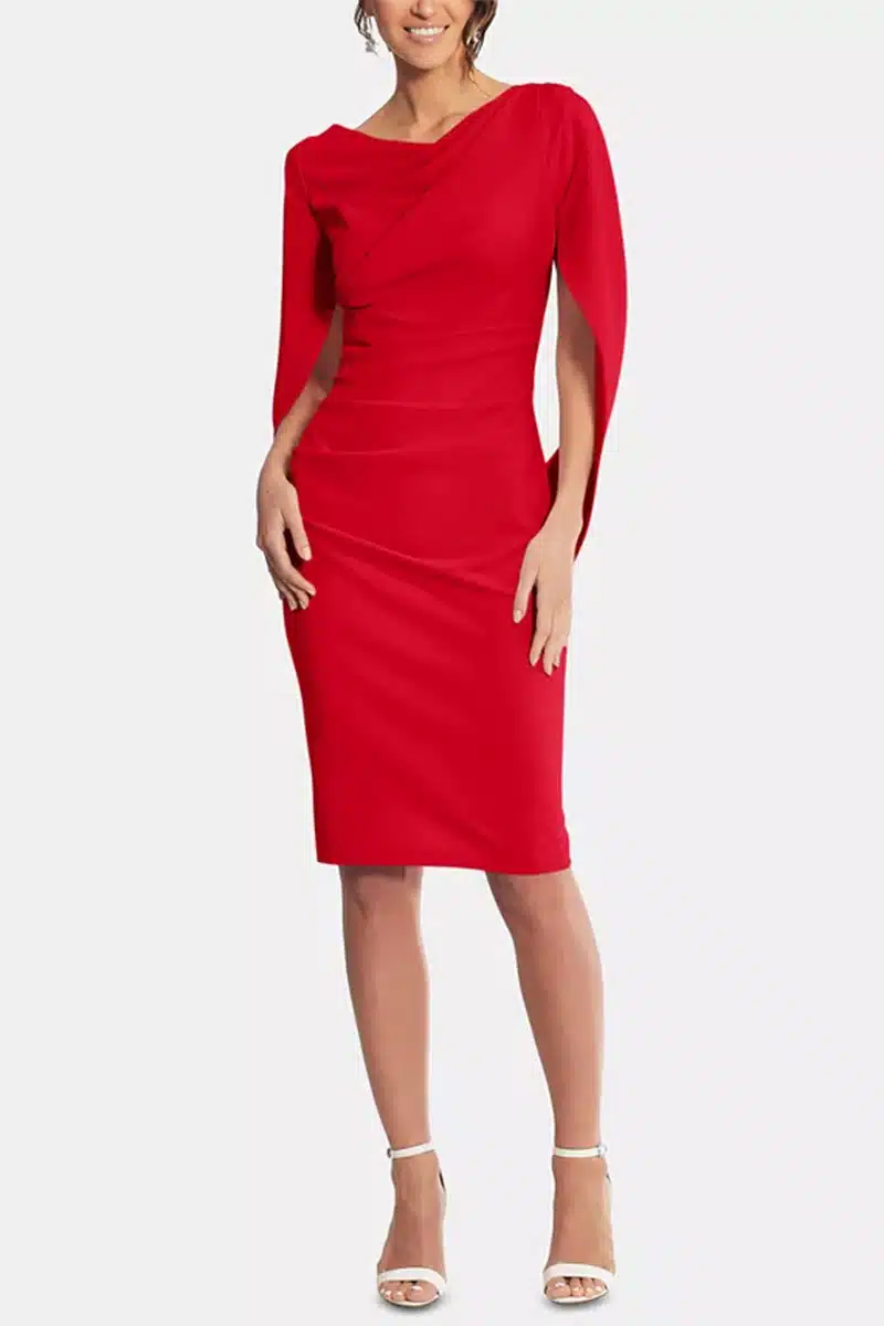 Model wears red sheath dress with cape.