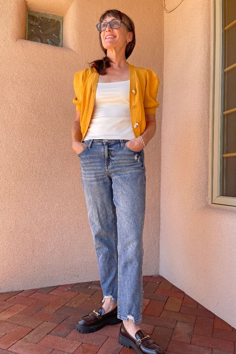 Catherine Brock wearing chunky loafers with cardigan and mom jeans.