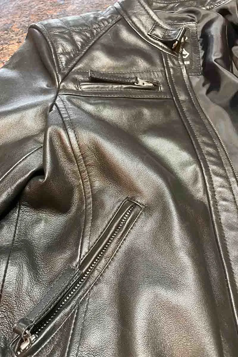 Close up view of leather moto jacket.